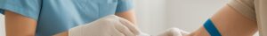 Nurse drawing blood for cholesterol test in Colchester clinic with vials